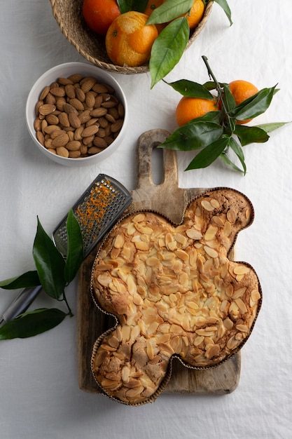 Flat lay delicious cake and tangerines