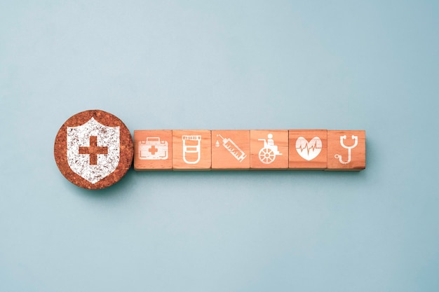 Flat lay design of Healthcare medical print screen on wooden cube block for assurance and insurance concept