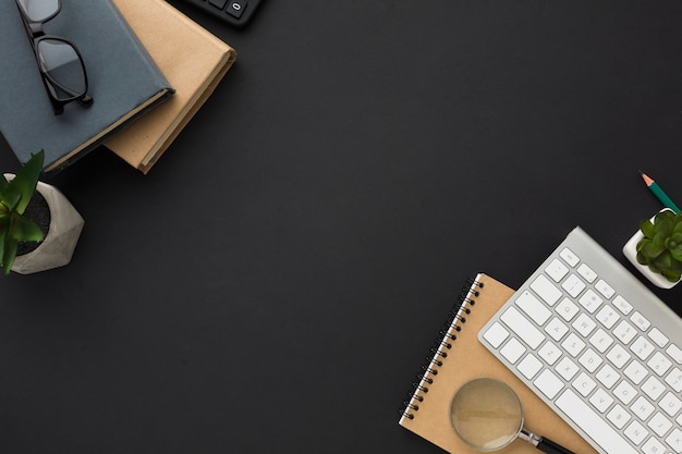 Flat lay of desktop with agendas and keyboard