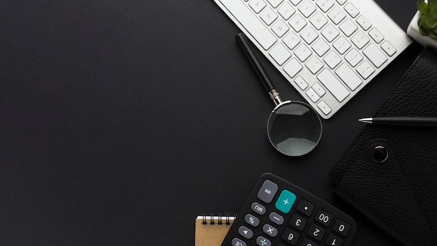 Flat lay of desktop with keyboard and calculator