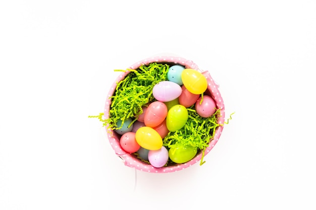 Flat lay. Easter basket with easter eggs on a white background.