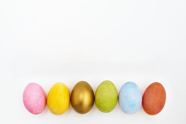 Flat lay of Easter eggs on white background Top view