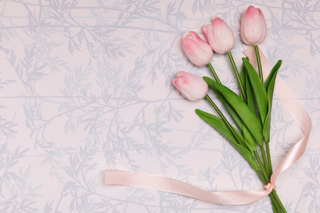 Flat lay frame with tulips on floral background