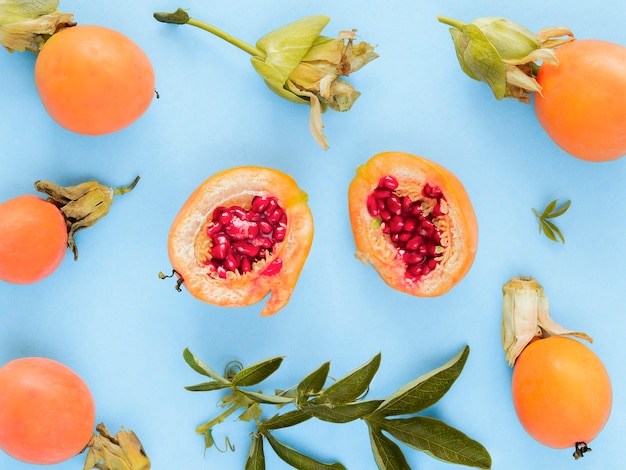 Flat lay fresh unripe pomegranates with leaves isolated