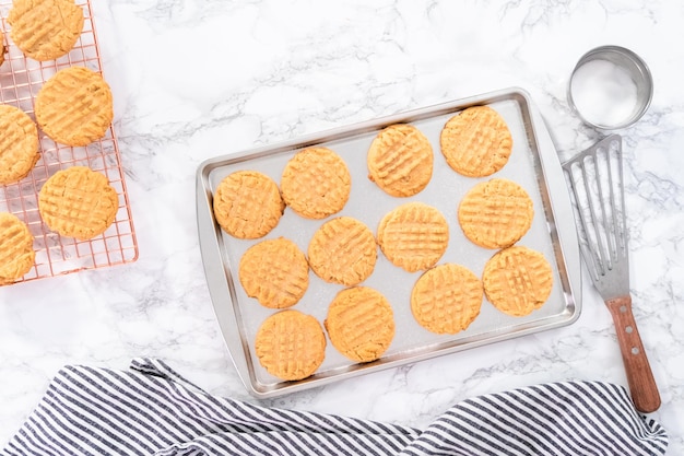 Flat lay. Freshly baked peanut butter cookies on a baking sheet.