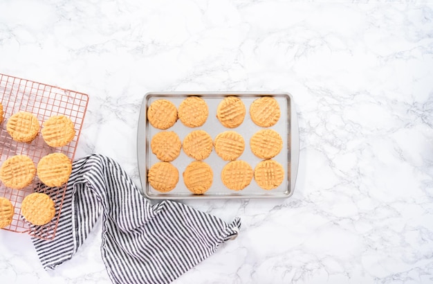 Flat lay. Freshly baked peanut butter cookies on a baking sheet.