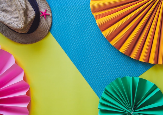 Flat lay of a hat and paper flowers Summer holiday concept 