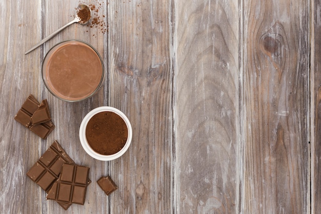 Flat lay of hot chocolate cup with cocoa powder