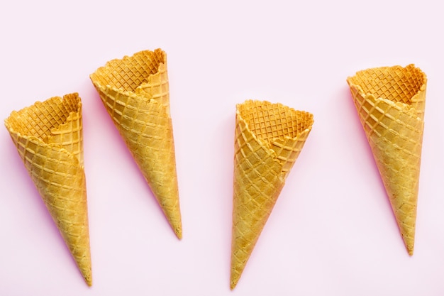 Flat lay ice cream cones collection on pink  background .