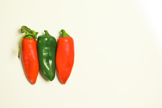 Flat lay image featuring vibrant capsicums on white background