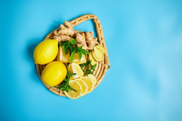 Flat lay of Immune boosting remedy immunity boosting foods ginger and lemon on blue background