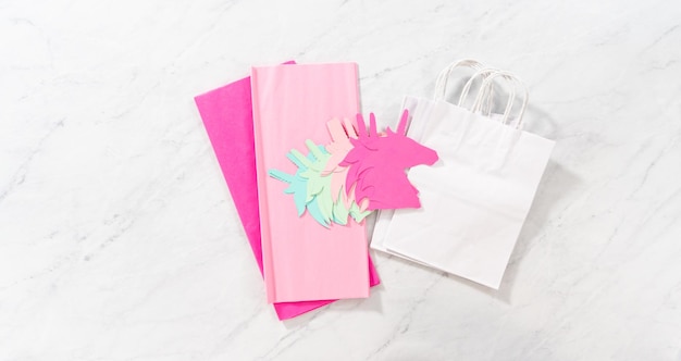 Flat lay. Materials to make unicorn Birthday party favor bags for a little girl's Birthday party.