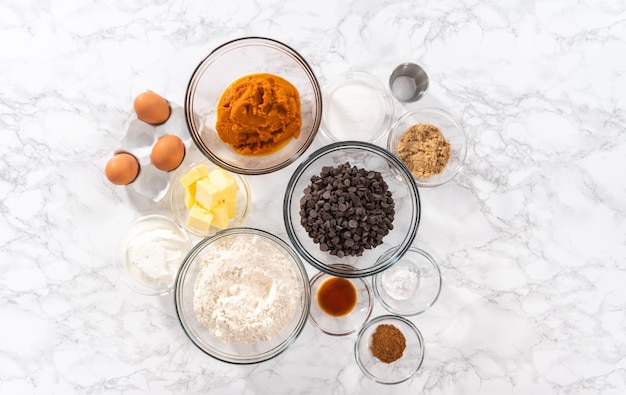 Flat lay Measured ingredients in a glass mixing bowl to bake chocolate pumpkin bundt cake with toffee glaze