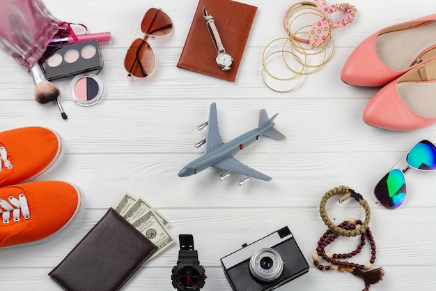 Flat lay mens and womens accessories and toy plane