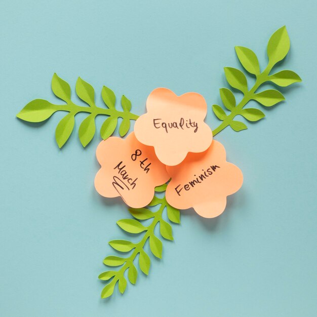 Flat lay of messages on sticky notes in shape of flowers for women's day