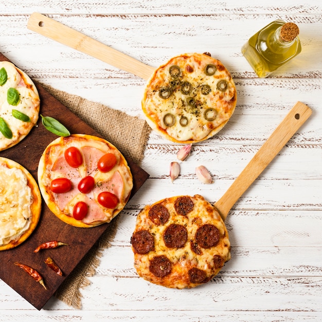 Flat lay of mini pizza on wooden tray