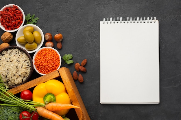 Flat lay of notebook mock-up and vegetables