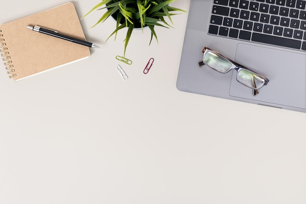 Flat lay office desk table with laptop notebook and eyeglasses Workspace with copy space