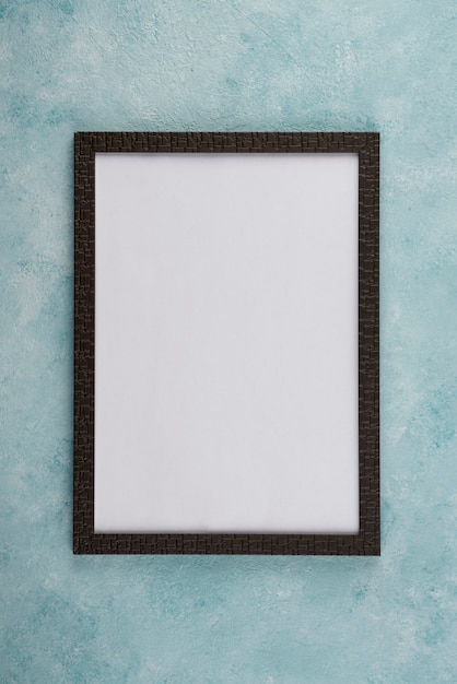 Flat lay of photo frame on textured surface