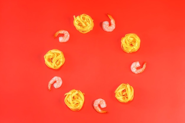 Flat lay photo of Ingredients for italian pasta on red background