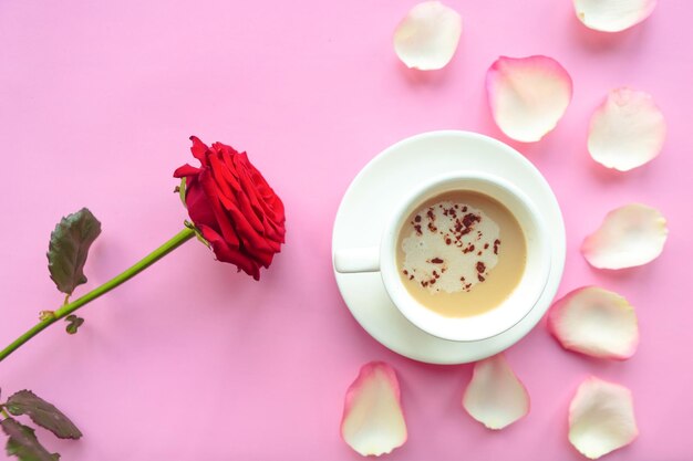 Flat lay photo with coffee cup and red rose on pink background Valentines Day or Wedding greeting card Love concept