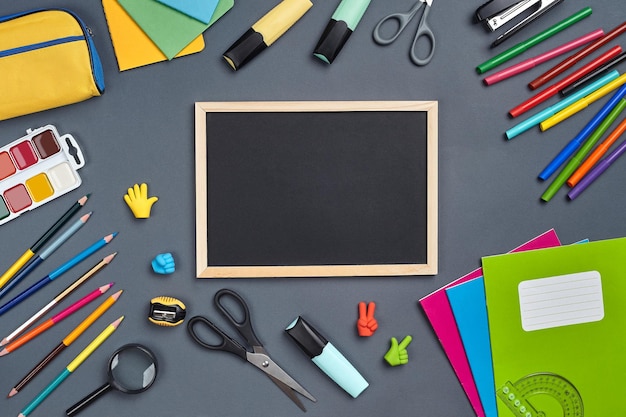 Flat lay photo of workspace desk with school accessories or office supplies on gray background