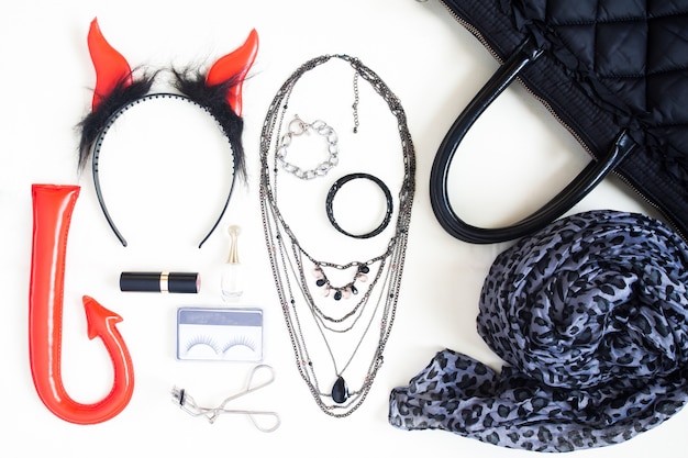 Flat lay photography with Halloween fashion accessories, cosmetics, essential items for woman, Overhead view of Halloween accessories items, top view