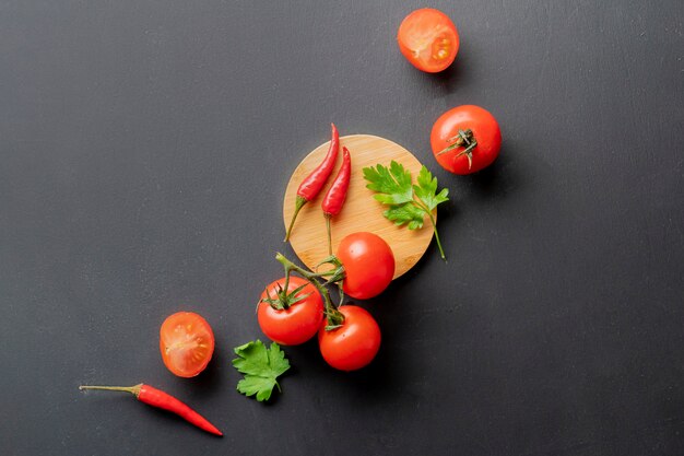 Flat lay red fresh organic natural cherry tomatoes on the table, vegan salad ingredients