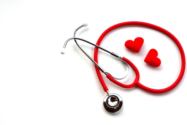 Flat lay of red medical stethoscope and red hearts on white background using for healthcar