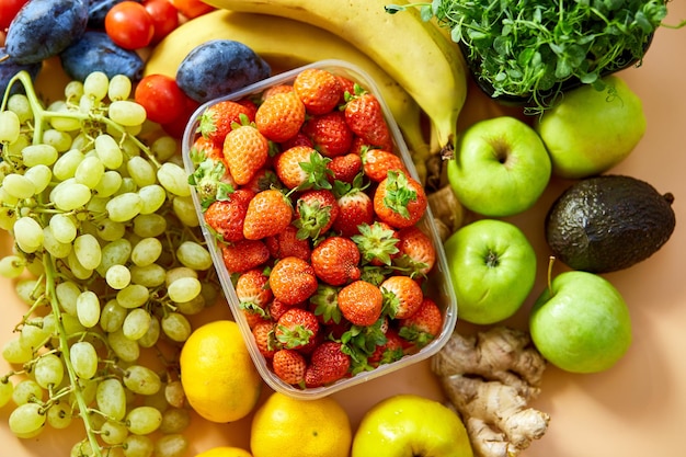 Flat lay of ripe organic healthy food Fruits microgreens vegetables on orange background copy space for text top view market local farm concept harvest food delivary diet vegan concept