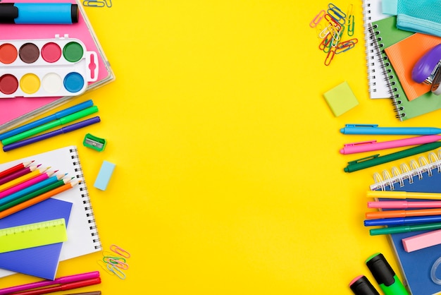 Flat lay of school essentials with colorful pencils and copy space