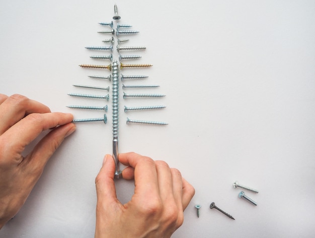 Flat lay of screws lined up in Christmas tree shape