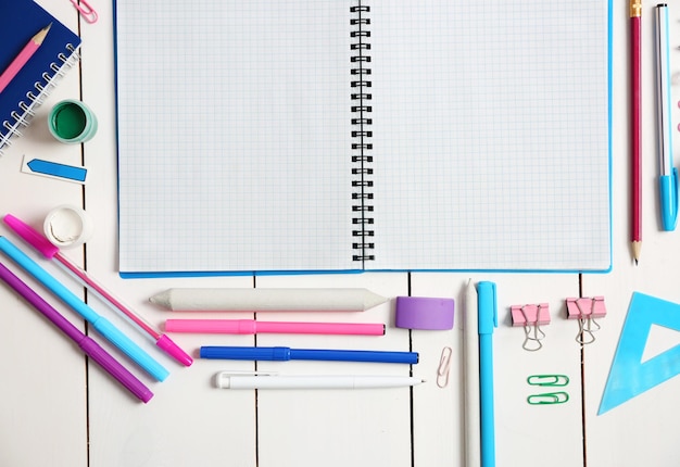 Flat lay of stationery on white wooden table background copy space