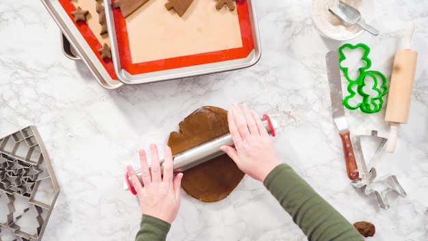 Flat lay. Step by step. Rolling out gingerbread cookie dough to bake Christmas cookies.