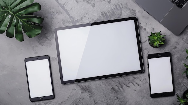 Photo a flat lay of a tablet phone and laptop with blank screens surrounded by plants