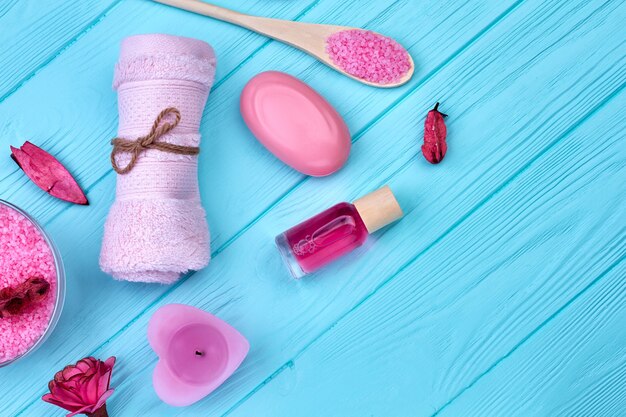 Flat lay top view bathroom stuff on blue wooden desk. Set of spa accessories.