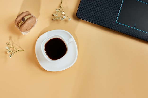 Flat lay top view office table desk workspace with laptop macaroon with coffee cup