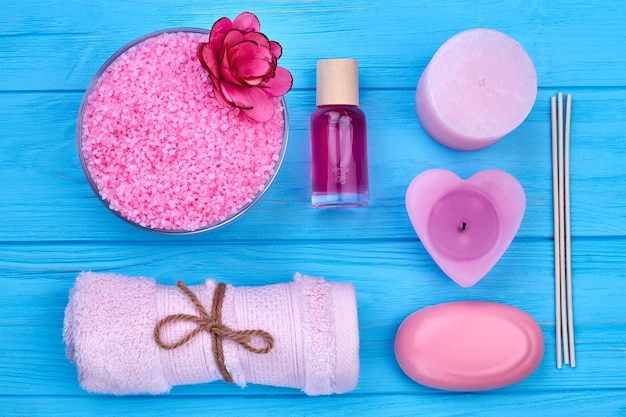 Flat lay top view set of accessories for bath and beauty. Blue wooden desk background.