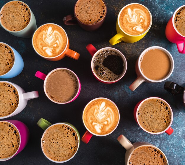 Flat lay top view of set of different types of coffee in mugs