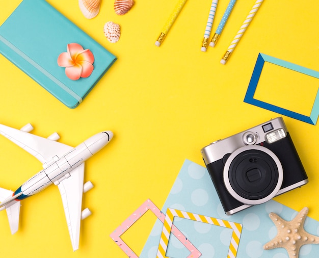 Flat lay travel accessories on yellow table