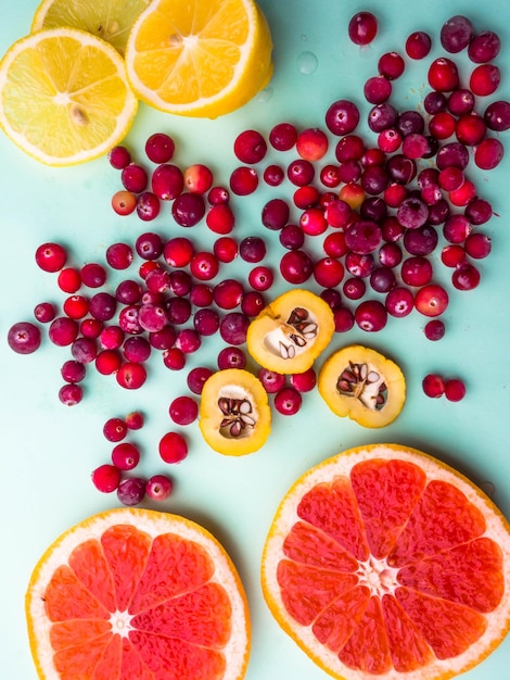 Flat lay trendy seamless pattern sliced mixed citrus fruits like background with different berries concept of healthy eating dieting top down