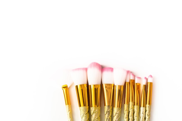 Flat lay. Unicorn-themed makeup brush set on a white background.