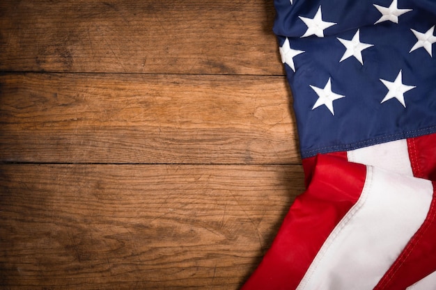 Flat lay USA flag on brown wooden board vintage background with copy space top view Banner