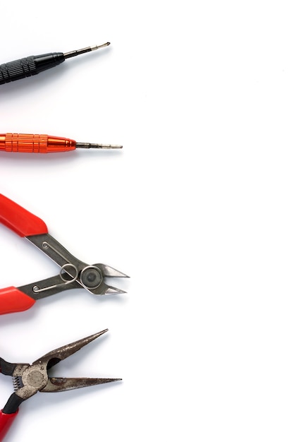 Flat lay of various craftsman tools or hand tools on white background.