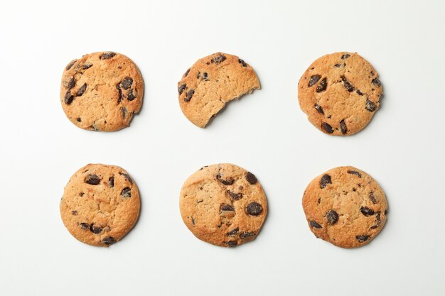 Flat lay with chocolate chip cookies on white