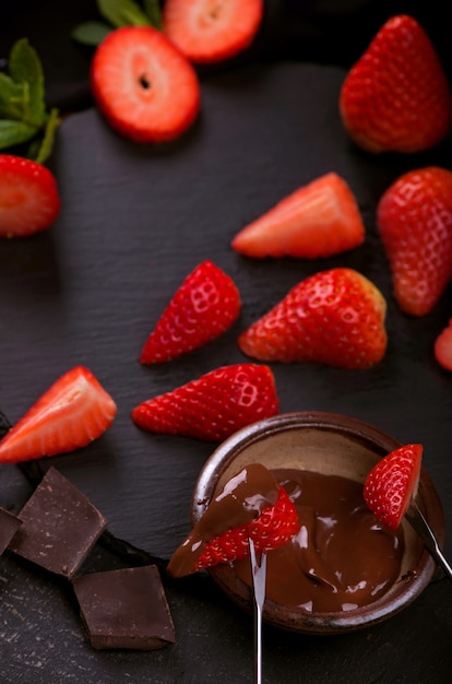 Flat lay with chocolate-covered strawberries on grey surface