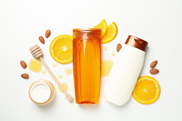 Flat lay with cosmetics and natural ingredients on white background