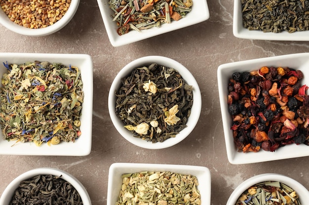 Flat lay with different types of tea on textured background