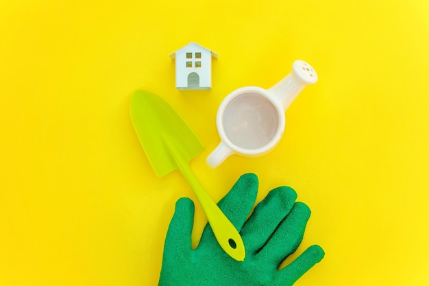 Flat Lay with gardening tools on yellow background