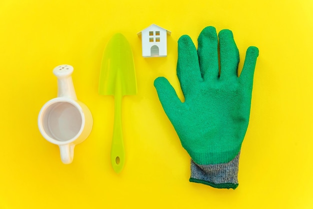 Flat Lay with gardening tools on yellow background